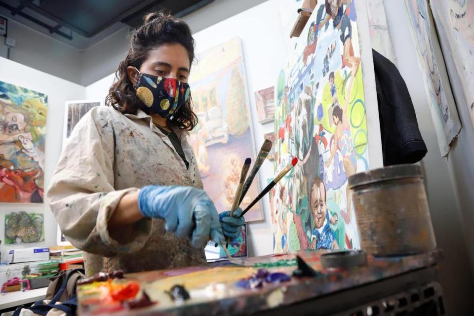 Artist Samantha Rosado mixes paint in her new studio at the McColl Center for Art + Innovation on Tryon Street in uptown Charlotte. The McColl recently opened eight new studios, just for local artists. Rosado and seven other artists chosen by the McColl moved into the renovated third floor studios earlier this summer.