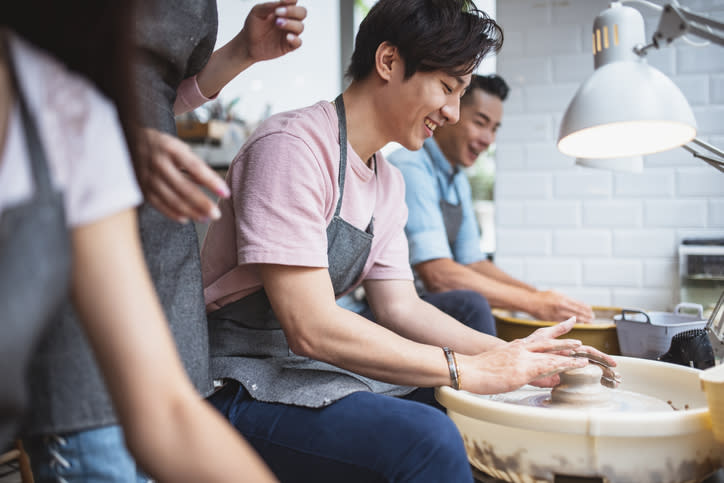 Learn how to shape clay in a pottery class 