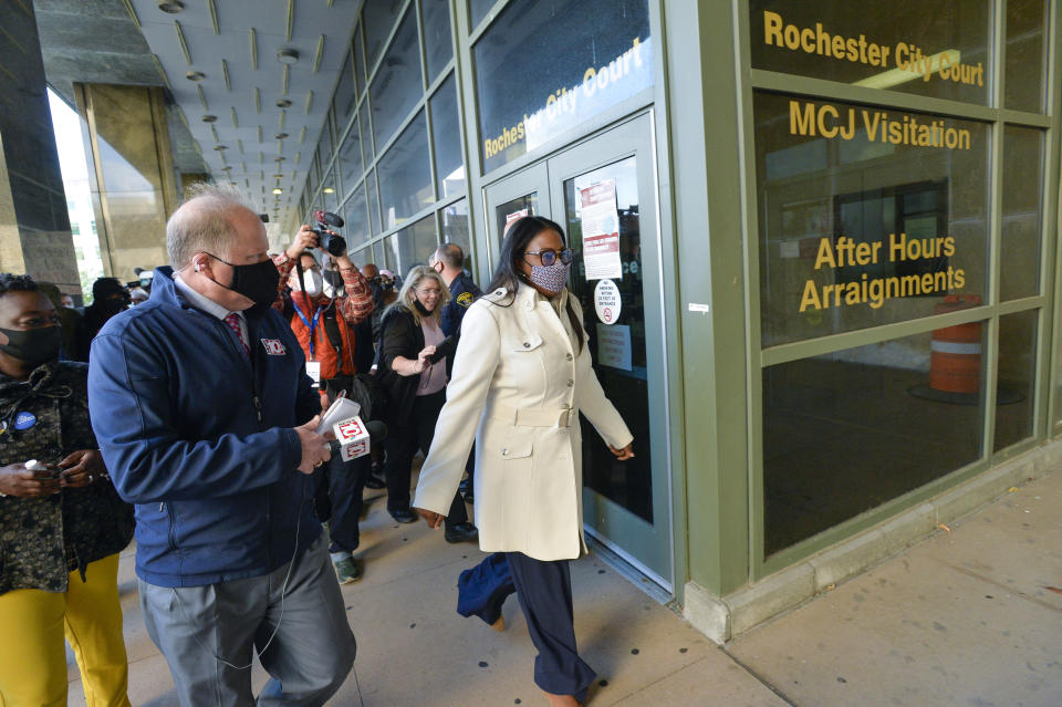 Rochester Mayor Lovely Warren, center, walks out of city court after her arraignment in Rochester, N.Y., Monday, Oct. 5, 2020. Warren, who has faced calls to resign over her city's handling of the suffocation death of Daniel Prude at the hands of police, pleaded not guilty Monday to campaign finance charges dating to her 2017 reelection campaign. (AP Photo/Adrian Kraus)