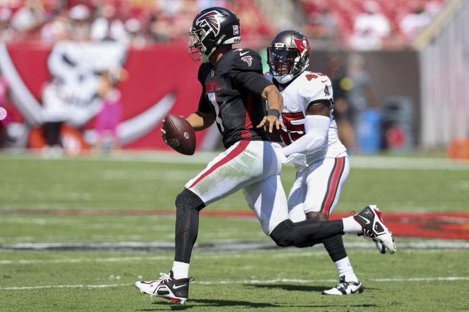 Atlanta Falcons quarterback Marcus Mariota (1) runs against Tampa Bay Buccaneers linebacker Devin White (45) during the first half of an NFL football game Sunday, Oct. 9, 2022, in Tampa, Fla. (AP Photo/Mark LoMoglio)