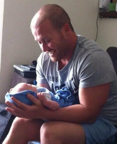 wayde kelly with his newborn son kyden.