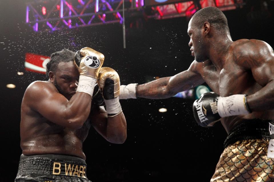 WBC heavyweight champion Bermane Stiverne (L) takes a punch from Deontay Wilder during their title fight at the MGM Grand Garden Arena on January 17, 2015 in Las Vegas, Nevada (AFP Photo/Steve Marcus)