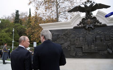 Mr Putin discusses a bronze relief of Alexander III's ostensible achievements, some of which did not actually occur during the emperor's reign, Internet users pointed out.  - Credit: Alexei Druzhinin/TASS via Getty Images