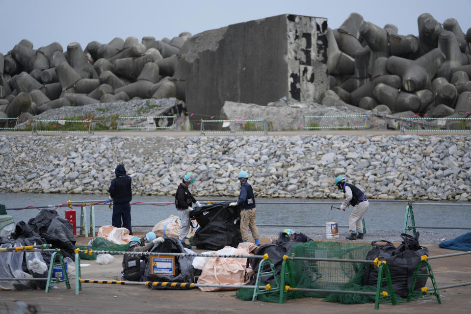 People work at the Fukushima Daiichi nuclear power plant, operated by Tokyo Electric Power Company Holdings, also known as TEPCO, in Futaba town, northeastern Japan, Friday, July 14, 2023. (AP Photo/Hiro Komae)