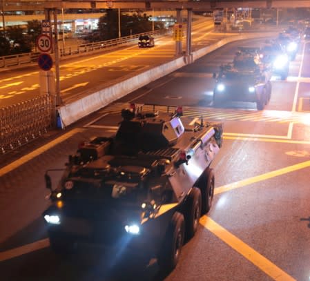 Military vehicles of the Chinese People's Liberation Army (PLA) pass Huanggang Port for a routine troop rotation in Hong Kong