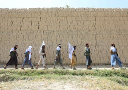 Taliban walk as they celebrate ceasefire in Ghanikhel district of Nangarhar province, Afghanistan June 16, 2018.REUTERS/Parwiz