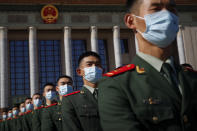 Chinese paramilitary policemen wearing face masks to help curb the spread of the coronavirus march outside the Great Hall of the People after attending the commemorating conference on the 70th anniversary of China's entry into the 1950-53 Korean War, in Beijing Friday, Oct. 23, 2020. (AP Photo/Andy Wong)