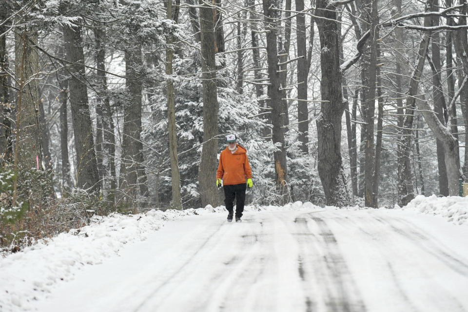 Kenneth Wolfe, of Pine Grove, walks along Clubhouse Road by Sweet Arrow Lake County Park in Pine Grove, Pa., on Friday, Jan. 28, 2022. (Jacqueline Dormer/Republican-Herald via AP)