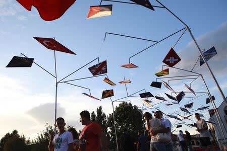 Kosovars and foreign visitors cross one of the bridges of the Ottoman town of Prizren, southwest of capital Pristina, during Dokufest August 20, 2014. REUTERS/Hazir Reka