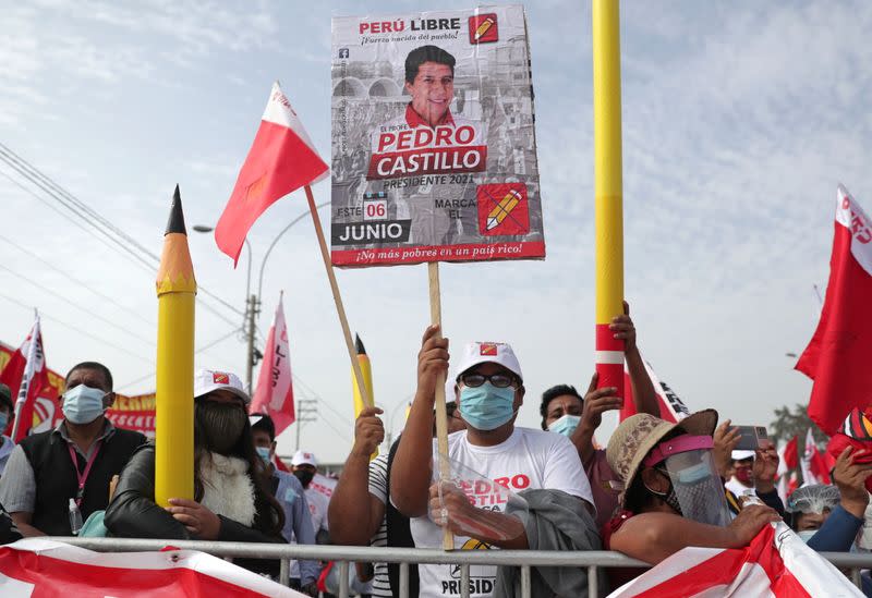 A supporter holds a sign in support of Peru's socialist presidential candidate Castillo in Lima