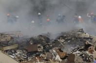 Firefighters work on the side of fire of Surmalu market about two kilometers (1.2 miles) south of the center Yerevan, Armenia, Sunday, Aug. 14, 2022. A strong explosion at a fireworks storage area has ripped through a market in Armenia's capital. At least one person has been killed and about 20 others have been injured. The blast on Sunday set off a large fire. (Vahram Baghdasaryan/Photolure via AP)