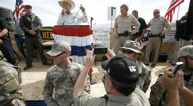 Rancher Cliven Bundy (back second left) talks on stage beside Clark County Sheriff Douglas Gillespie (back third left) in Bunkerville, Nevada, April 12, 2014. Photo: Reuters.