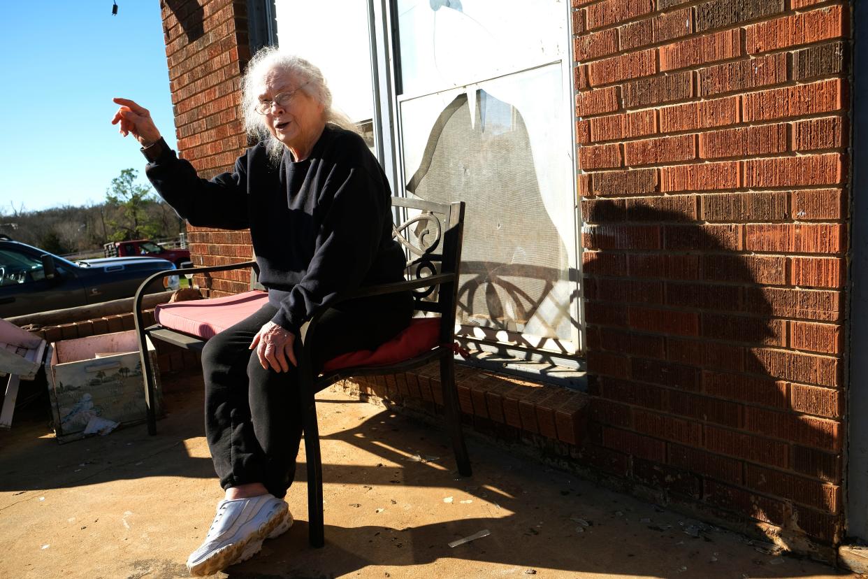 Jean Hopkins, 83, talks to reporters Monday about what happened Sunday night when a tornado destroyed her Norman home and how she survived, "but for the grace of God," while taking shelter in her bedroom closet, the only room where the ceiling remained in place. Hopkins is sitting on the front porch of Teresa Elam, her daughter, who lives next door. Hopkins has another daughter who lives across the street.