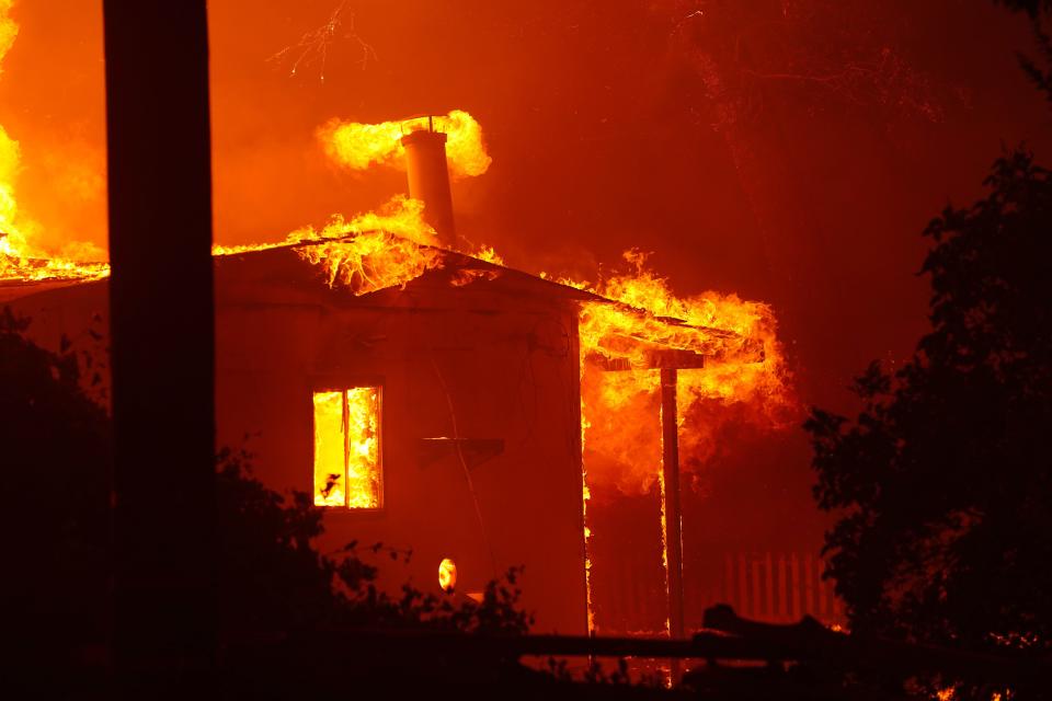 A structure is engulfed in flames on July 26, 2024, as the Park Fire roared across Highway 36 near Paynes Creek.