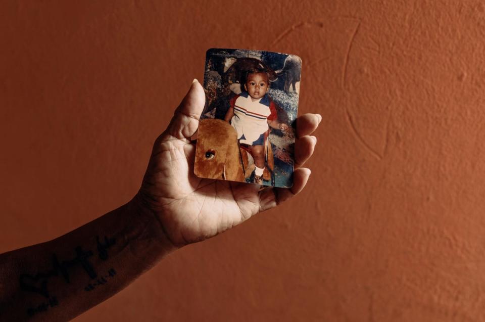 Delphine holds a photograph of her murdered son, Julio, who was recruited by a gang while serving a prison sentence for possession of marijuana and killed just metres from their home (Paddy Dowling/Care Ecuador)