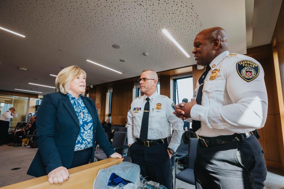 Framingham Police Chief Lester Baker, right, and Deputy Police Chief Sean Riley speak with Minister of State for Mental Health and Older People Mary Butler recently while presenting the model of their Jail Diversion Program in Limerick, Ireland.