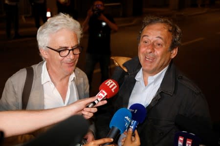 Former head of European football association UEFA Michel Platini and his lawyer William Bourdon speak with the media after leaving a judicial police station where Platini was detained for questioning over the awarding of the 2022 World Cup soccer tournamen