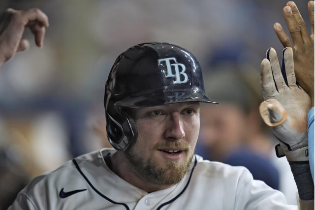 Tampa Bay Rays pitchers Josh Fleming, left to right, Zach Eflin and Shane  McClanahan laugh in the dugout after watching infielder Luke Raley pitch  during a baseball game against the Toronto Blue