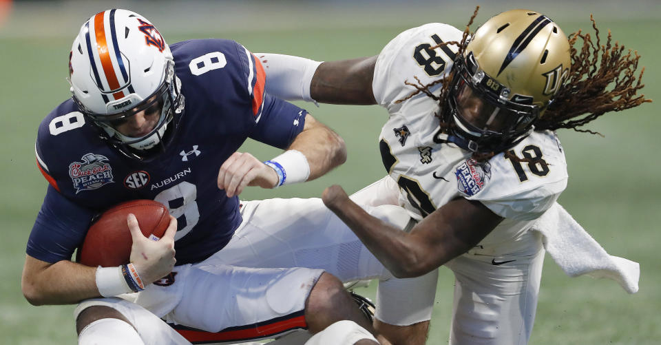 Central Florida linebacker Shaquem Griffin (18) sacks Auburn quarterback Jarrett Stidham (8) during the second half of the Peach Bowl NCAA college football game, Monday, Jan. 1, 2018, in Atlanta. (AP Photo/John Bazemore)