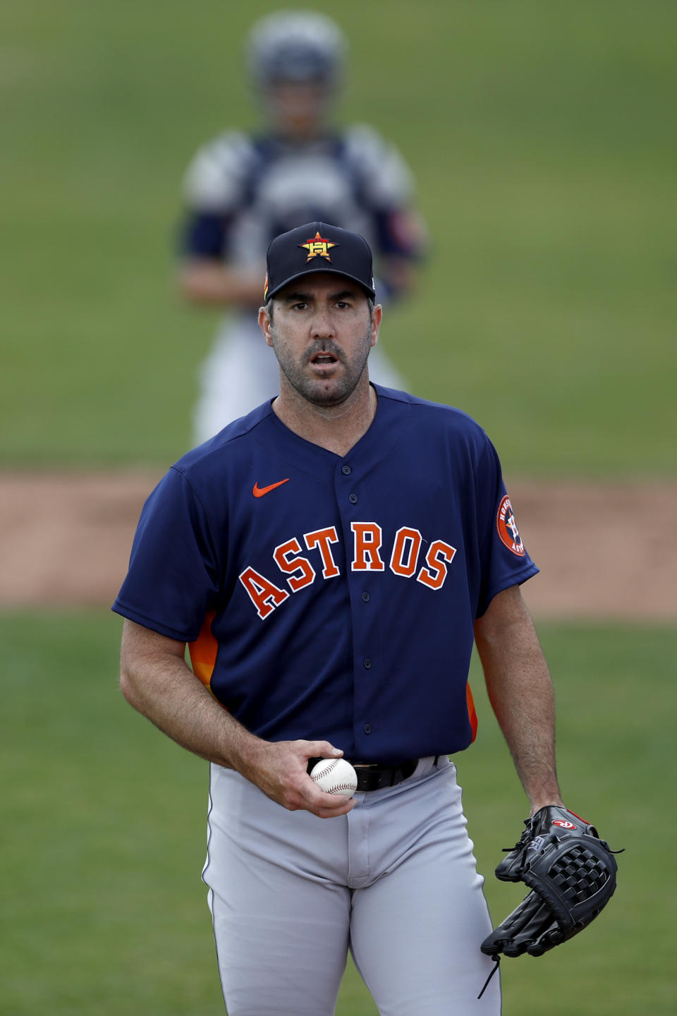 Houston Astros pitcher Justin Verlander warms up prior to a spring training baseball game against the St. Louis Cardinals, Tuesday, March 3, 2020, in Jupiter, Fla. (AP Photo/Julio Cortez)