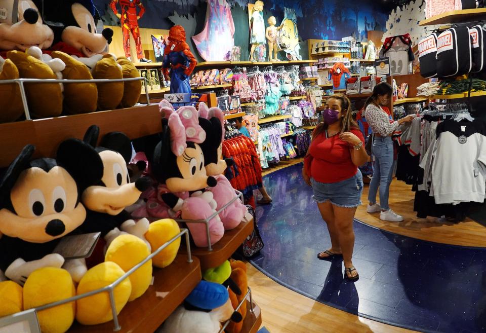 Shoppers visit a closing Disney Store in Miami, Florida, in 2021.