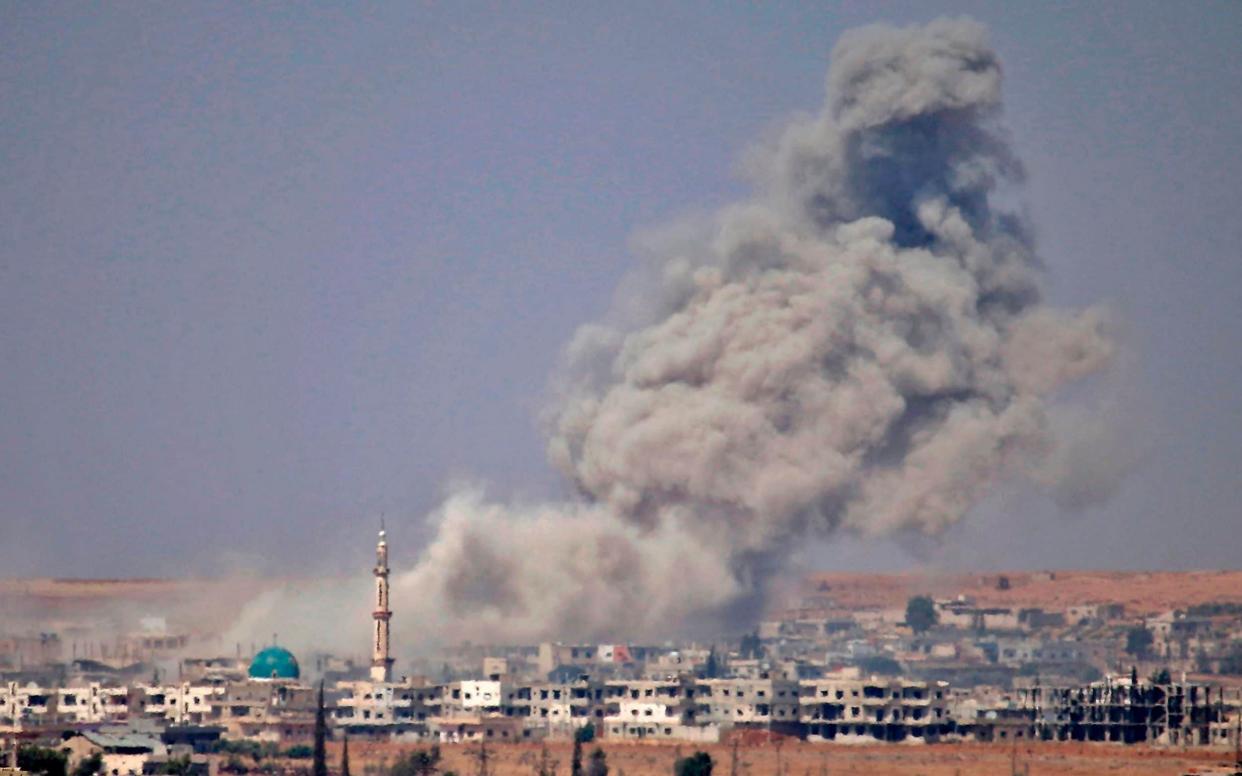 Smoke rises above rebel-held areas east of the city of Daraa during reported airstrikes by Syrian regime forces  - AFP