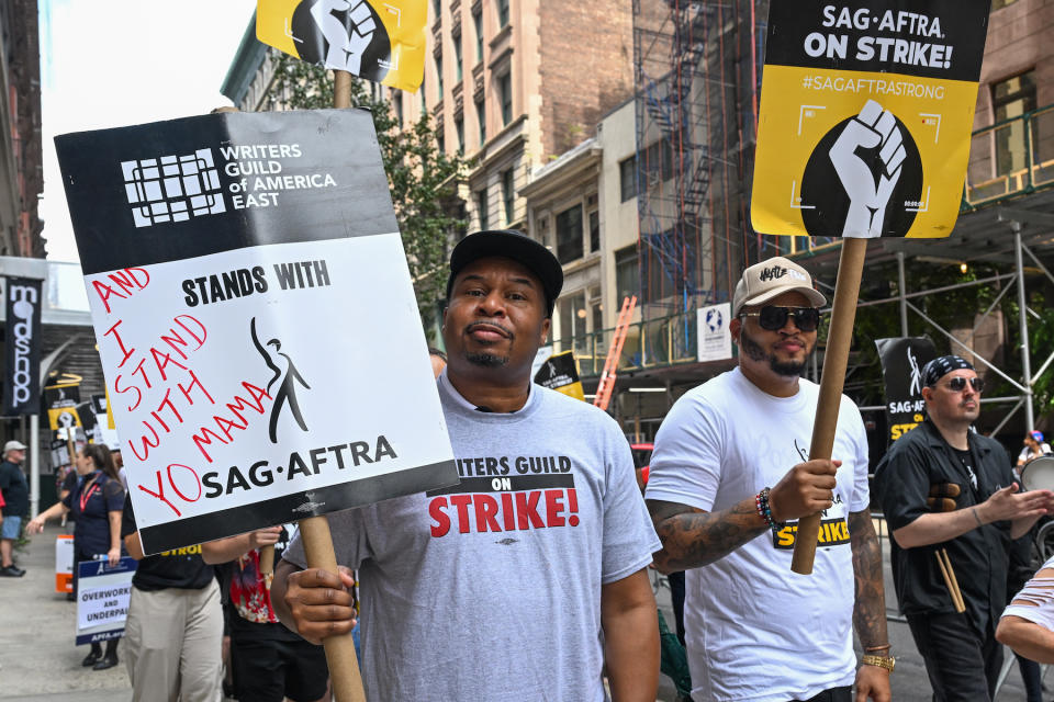 NEW YORK, NEW YORK - AUGUST 17: Comedian Roy Wood Jr. joins flight attendants, members, and supporters of the WGA and SAG-AFTRA on the picket line outside Netflix and Warner Bros. on August 17, 2023 in New York City. Airline flight attendant unions, including The Association for Professional Flight Attendants, which represents over 26,000 from American Airlines are voting later this month if they should strike alongside fellow flight attendants from Southwest and Alaska Airlines who are already on strike. One of the main objectives for flight attendants are to be paid for time boarding, and on the ground, not just for actual flight time. Members of SAG-AFTRA, Hollywood’s largest union which represents actors and other media professionals, joined striking WGA (Writers Guild of America) workers in the first joint walkout against the studios since 1960. The strike has shut down Hollywood productions completely with writers in the third month of their strike against the Hollywood studios. (Photo by Alexi Rosenfeld/Getty Images)