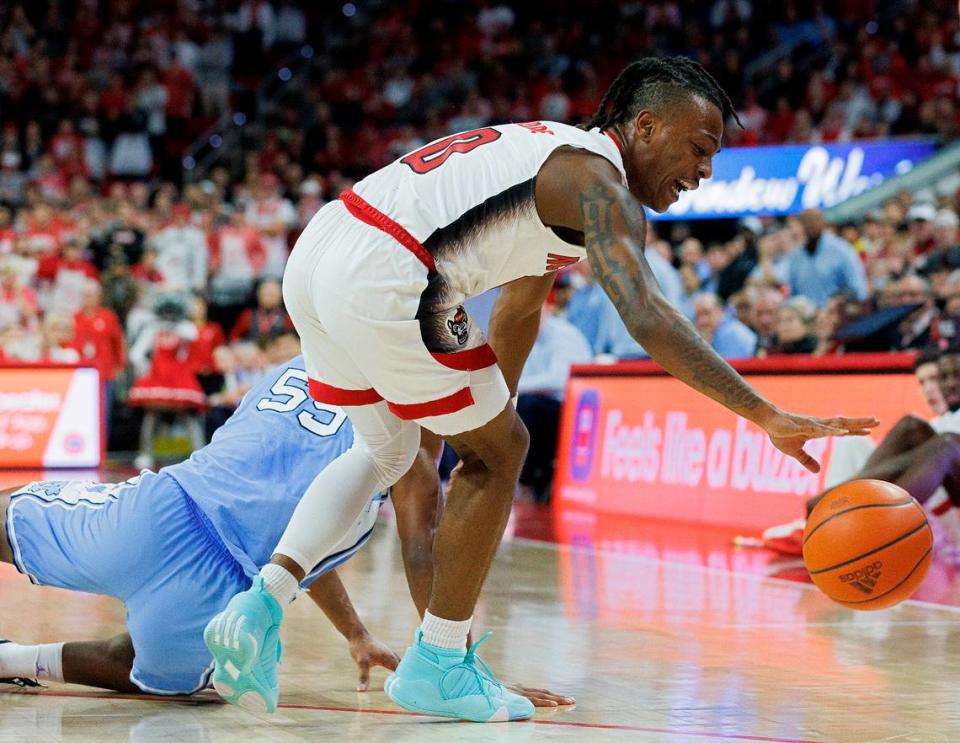 N.C. State’s DJ Horne handles the ball in front of North Carolina’s Harrison Ingram during the first half of the Wolfpack’s game at PNC Arena on Wednesday, Jan. 10, 2024, in Raleigh, N.C.