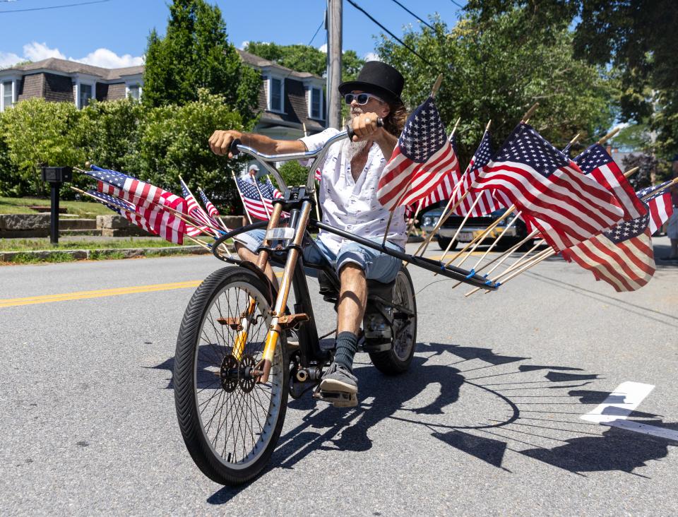 A bicyclist expressed his patriotism with an American flag display at the Fourth of July parade on Monday in Sandwich.