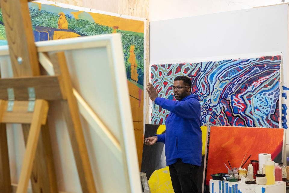 Artist Senghor Reid, featured in the short film, "‘Senghor Reid: Make Way for Tomorrow," paints at his Detroit studio in March, 2022. The film is part of the 2023 Freep Film Festival.