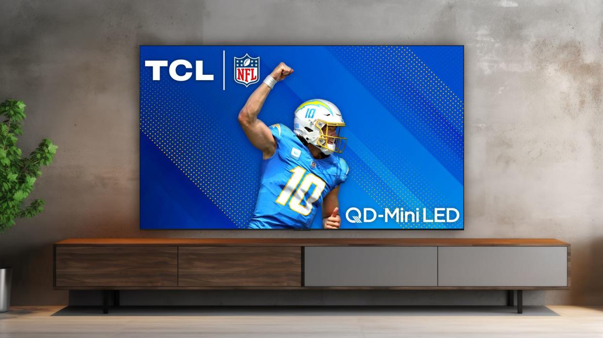  TCL QM89 in living room environment showing football. 