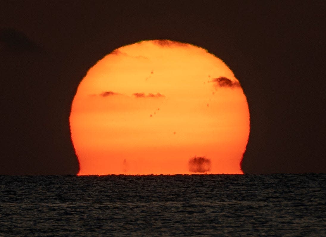 The sun rises at Coral Cove Park in Tequesta, Florida on July 10, 2023.