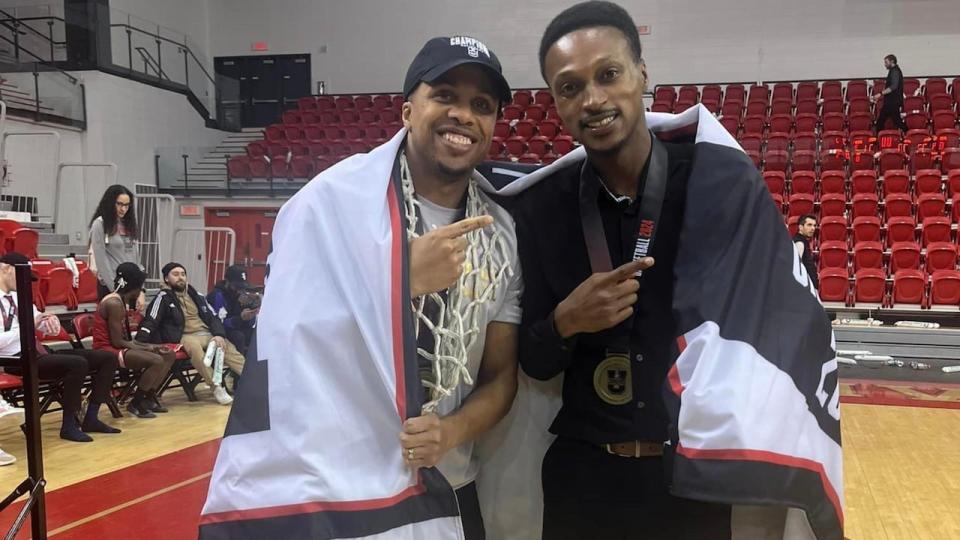 Nathan Grant, the head coach of the Rouge et Or, left, celebrated with his assistant coach and friend after their team won the Canadian men's basketball championship in March.