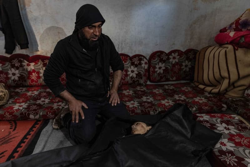 A relative of the child, Farida Hamami, mourns near her body after she was killed following a missile strike by the Syrian regime that targeted the town of Sarmin in Idlib. Anas Alkharboutli/dpa