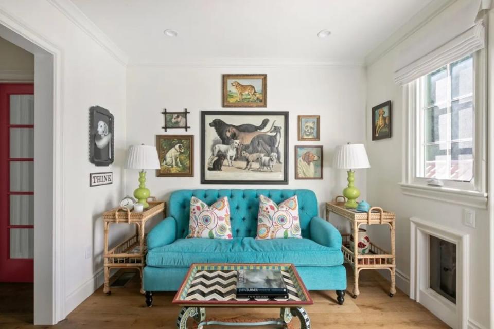 A gallery wall of dog portraits sits above the sofa in the kitchen (Ryan Lahiff/Sotheby's International Realty)