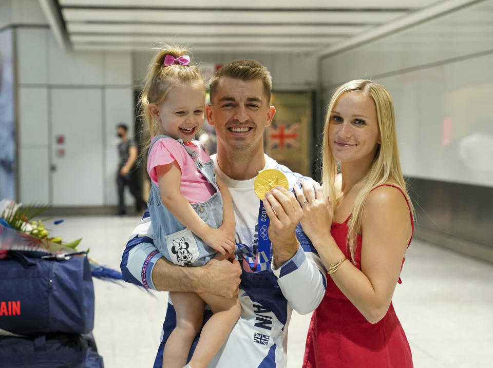 Olympic gymnast Max Whitlock, with his wife Leah and daughter Willow, as he arrives back at London Heathrow Airport from the Tokyo 2020 Olympic Games. Picture date: Tuesday August 3, 2021.