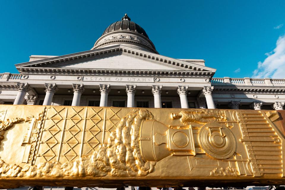 The Golden Spike Monument arrives in front of the Utah state Capitol in Salt Lake City on Monday, Oct. 23, 2023. The 43-foot-tall golden spike was commissioned as a public art piece by the Golden Spike Foundation to honor the tens of thousands of railroad workers who built the transcontinental railroad. | Megan Nielsen, Deseret News