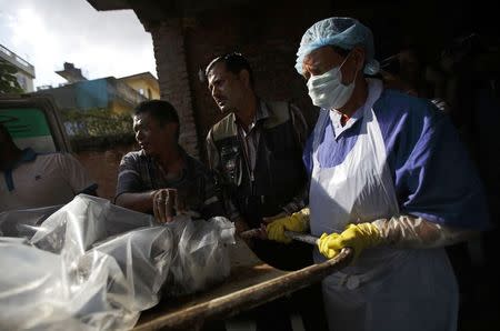 The body of a victim is moved from an ambulance to the morgue after it was brought back from Annapurna Region in Kathmandu October 17, 2014. REUTERS/Navesh Chitrakar