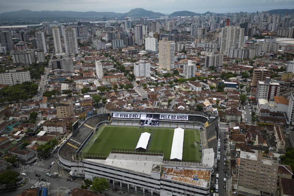 Giant banners that read in Portuguese: "Long live King Pele, 82 years", are displayed in the stands of the Vila Belmiro stadium, home of the Santos soccer club, where Pele's funeral will take place, in Santos, Brazil, Saturday, Dec. 31, 2022. Pele, who played most of his career with Santos, died in Sao Paulo on Thursday at the age of 82. (AP Photo/Matias Delacroix)