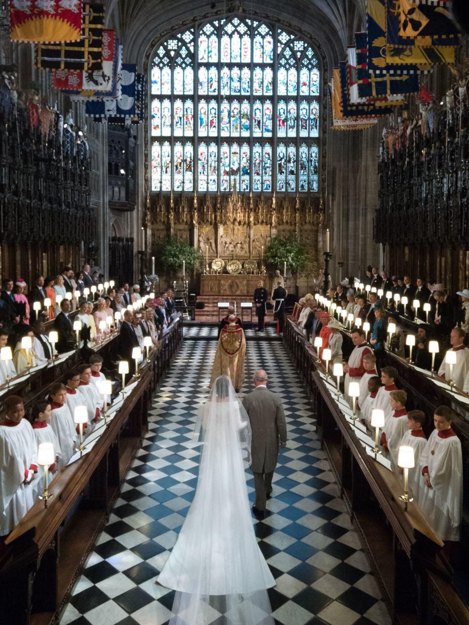 Meghan Markle walks up the aisle with the Prince Charles, Prince of Wales at St George's Chapel at Windsor Castle during her wedding to Prince Harry on May 19, 2018 in Windsor, England