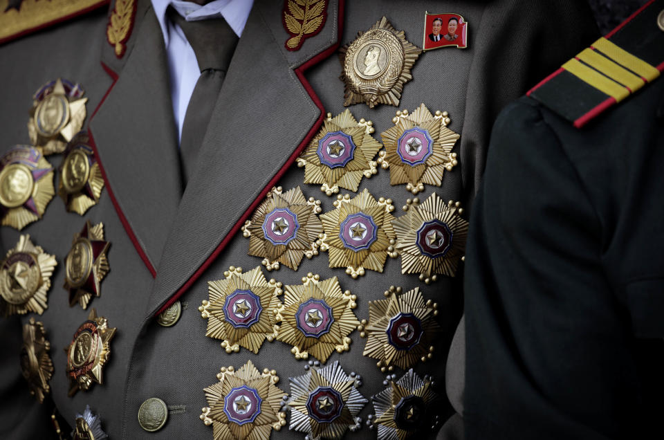 A North Korean war veteran is decorated with medals as he attends a parade to celebrate the anniversary of the Korean War armistice agreement, Sunday, July 27, 2014 in Pyongyang, North Korea. North Koreans gathered at Kim Il Sung Square as part of celebrations for the 61st anniversary of the armistice that ended the Korean War. (AP Photo/Wong Maye-E)