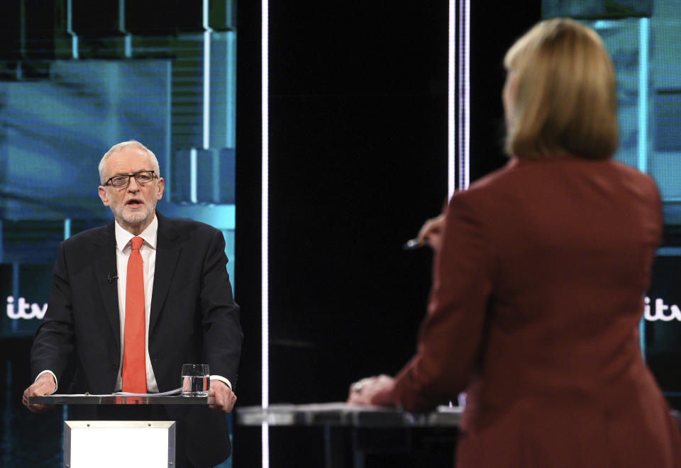 In this photo issued by ITV, Jeremy Corbyn during their election head-to-head debate live on TV, with debate adjudicator Julie Etchingham, right, in Manchester, England, Tuesday, Nov. 19, 2019. Prime Minister Boris Johnson and leader of the opposition Labour Party Jeremy Corbyn are set to go head-to-head in their first live televised debate Tuesday evening, as the UK prepares for a General Election on Dec. 12. (ITV via AP)