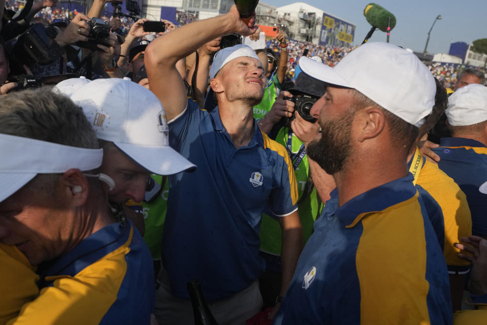 Europe's Nicolai Hojgaard, centre pours champagne over his head as Europe celebrate winning the Ryder Cup following the end of the their singles matches at the Ryder Cup golf tournament at the Marco Simone Golf Club in Guidonia Montecelio, Italy, Sunday, Oct. 1, 2023. (AP Photo/Gregorio Borgia )