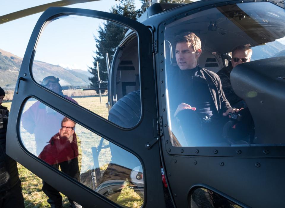 Director Christopher McQuarrie, in window reflection, and Tom Cruise on the set of "Fallout."