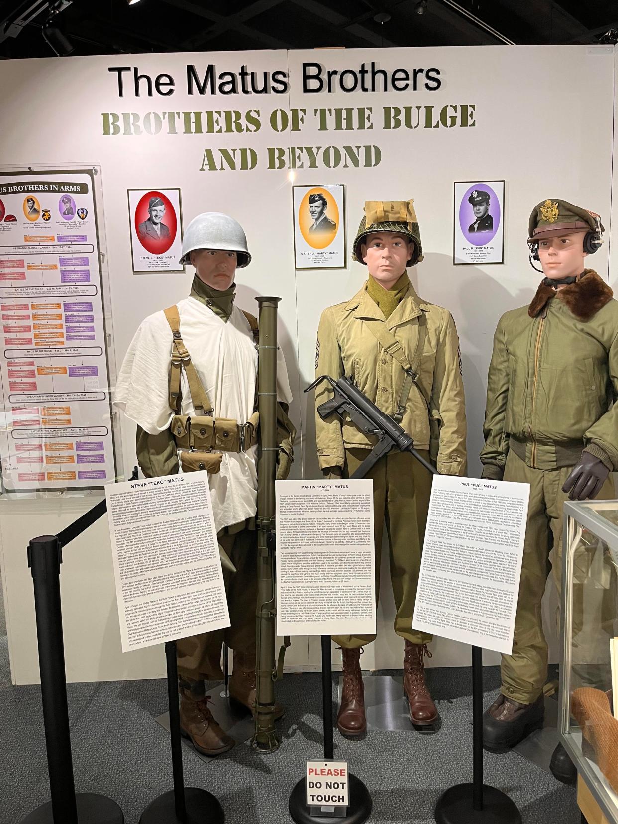 Scott Denniss, curator of MAPS Air Museum, dressed museum mannequins with the attire the Matus brothers would have worn during their service in the Army during World War II. Pictures of the brothers are behind the mannequins and biographies of each man are posted in a new exhibit, "Brothers of the Bulge and Beyond."