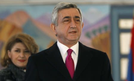 FILE PHOTO: Armenia's current President Serzh Sarksyan (R) and his wife Rita leave a polling station after voting during the presidential election in Yerevan, February 18, 2013.  REUTERS/David Mdzinarishvili