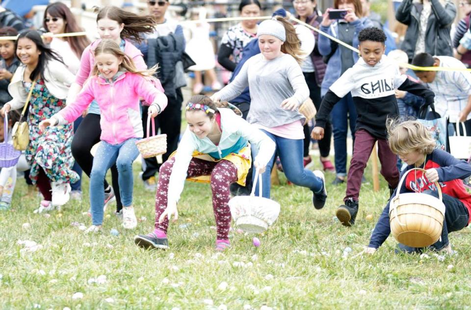 Kids dash to pick up eggs at the Egg-stravaganza Hunt at Dinosaur Caves Park in Pismo Beach in 2019. Easter egg hunts are scheduled across San Luis Obispo County in April 2023.