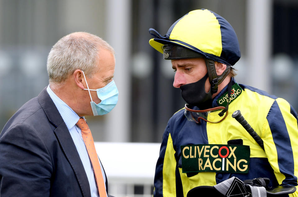 Jockey Adam Kirby (right) speaks to horse trainer Clive Cox after wining the Home Of Winners At valuerater.co.uk Handicap (Div 2) with Willy Nilly at Bath Racecourse.