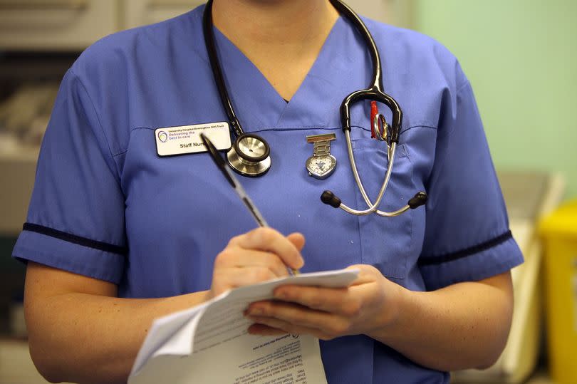 A staff nurse filling in paperwork