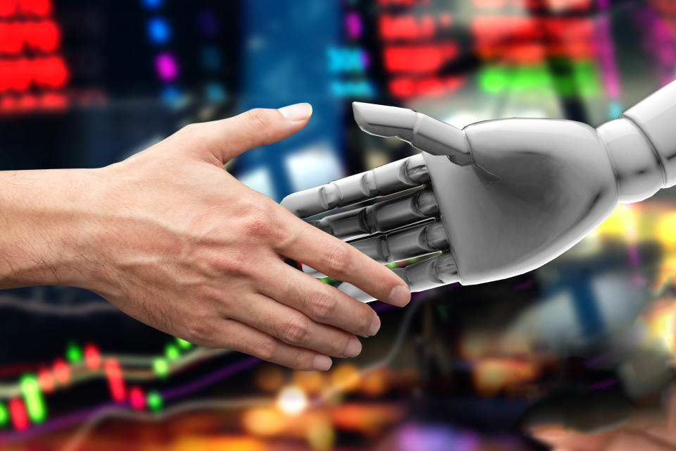 Artificial intelligence (AI) advisor or robo-advisor in stock financial market technology. Shaking hands of male investor and 3d rendering robot. Abstract graph stock exchange background.